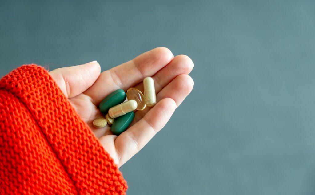Hand with daily supplements, health care