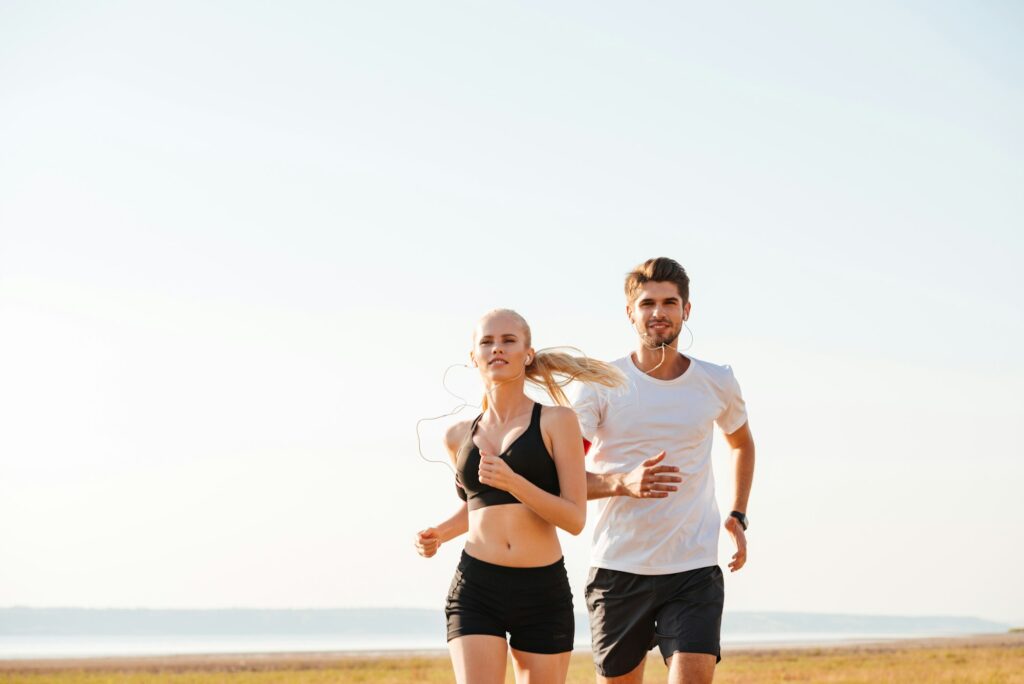 Smiling sports couple running outdoors